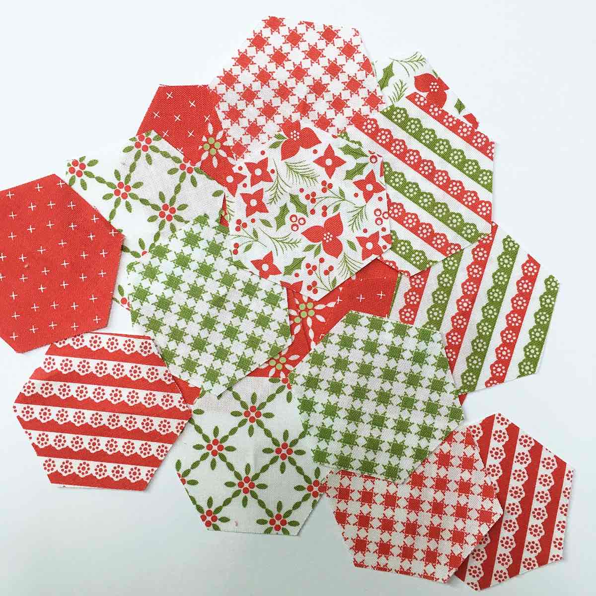 5-pile of green, red and white fabric hexagons