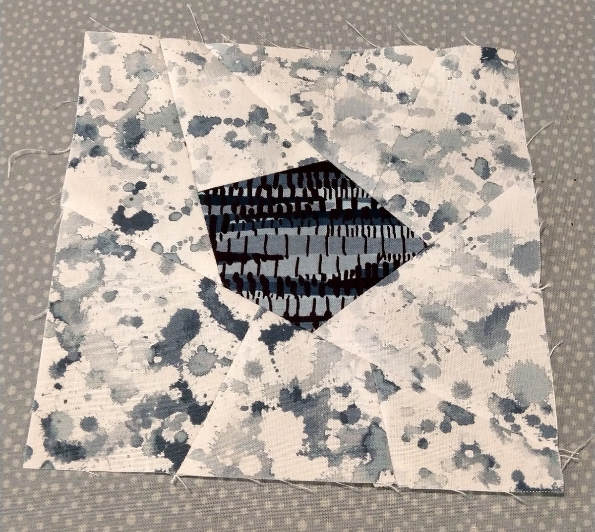 AccuQuilt GO Crazy Quilt 6-inch block sewn together made of white, grey and navy Michael Miller Fabrics.